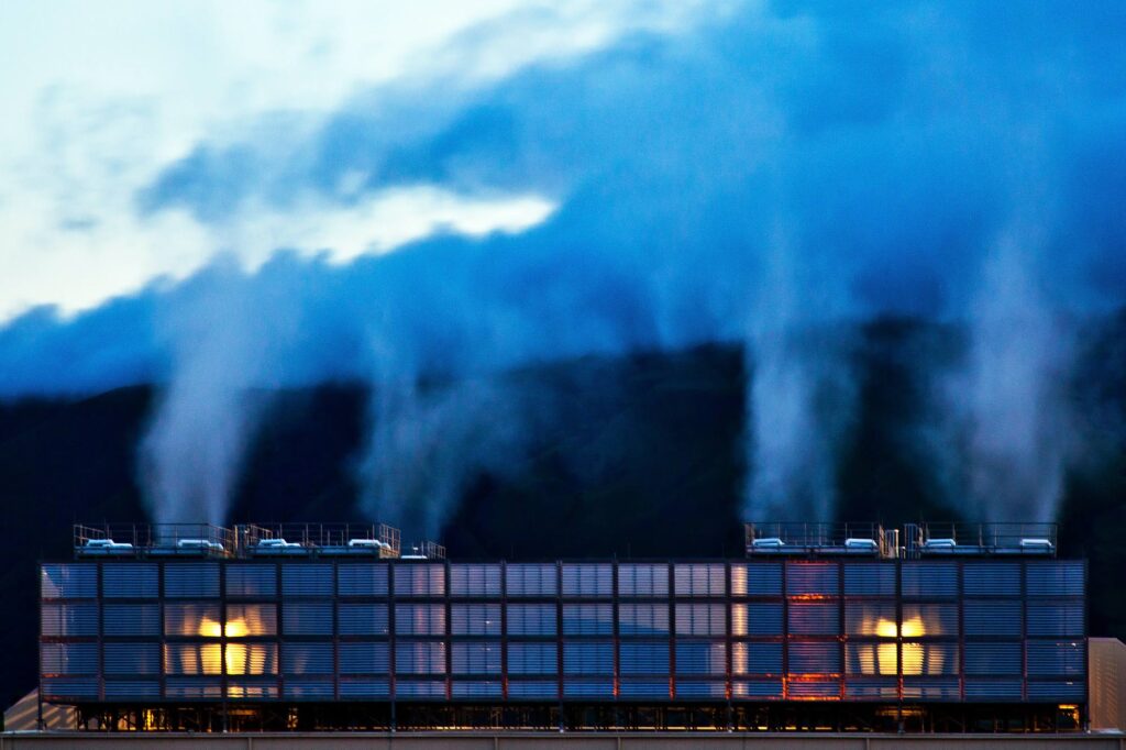 Steam rises above the cooling towers in The Dalles data center in Oregon. These plumes of water vapor create a quiet mist at dusk.